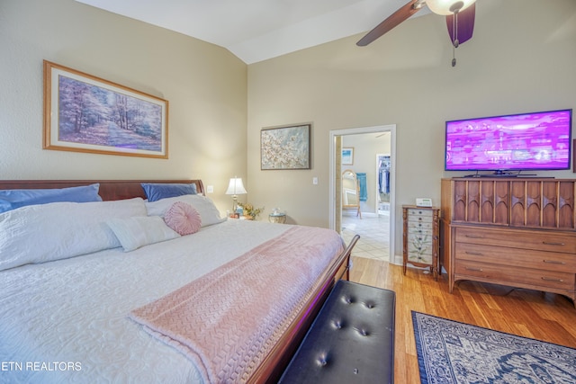 bedroom featuring ceiling fan, light hardwood / wood-style flooring, and vaulted ceiling