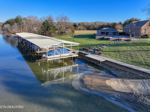 dock area featuring a lawn and a water view