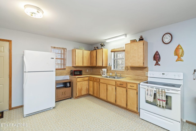 kitchen with decorative backsplash, sink, and white appliances