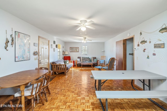 dining room featuring ceiling fan and light parquet flooring