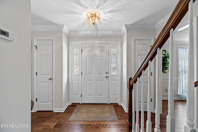 entryway with dark hardwood / wood-style floors, crown molding, and a textured ceiling