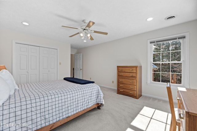 carpeted bedroom featuring a closet and ceiling fan