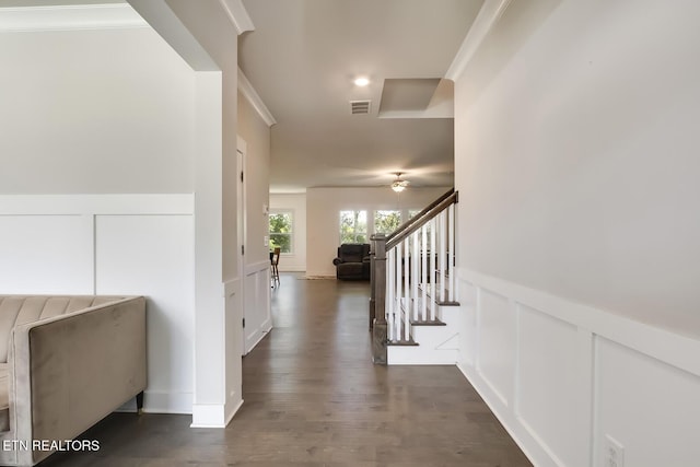 hall featuring dark wood-type flooring and ornamental molding