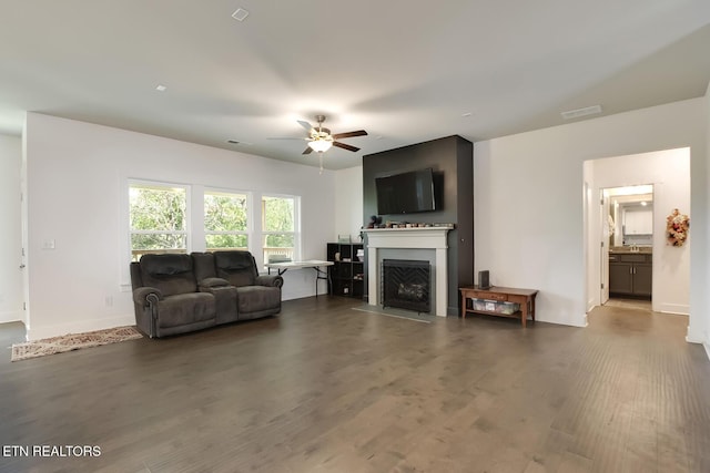 living room featuring dark hardwood / wood-style flooring and ceiling fan