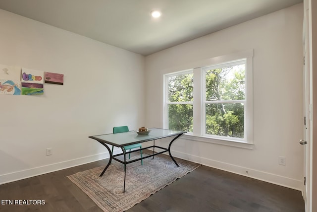 home office with plenty of natural light and dark wood-type flooring