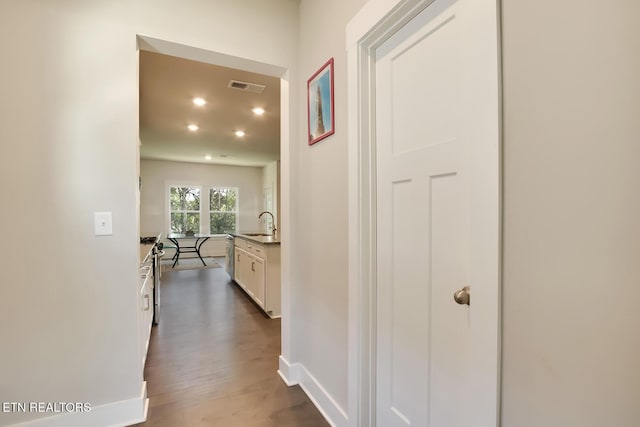 corridor featuring dark hardwood / wood-style flooring and sink