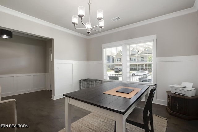 dining room featuring dark hardwood / wood-style flooring, an inviting chandelier, and ornamental molding