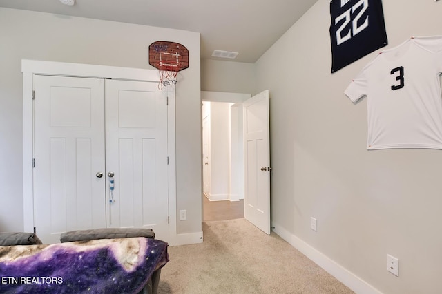 carpeted bedroom featuring a closet