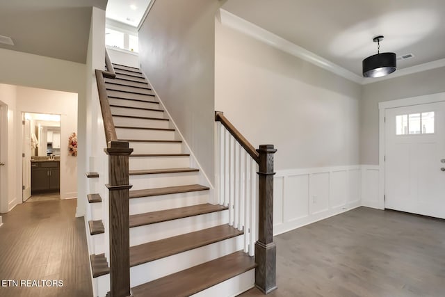 entryway featuring a healthy amount of sunlight, dark hardwood / wood-style floors, and ornamental molding