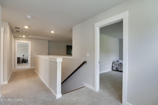 hallway with light colored carpet