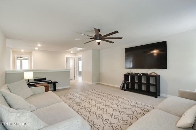 carpeted living room with ceiling fan