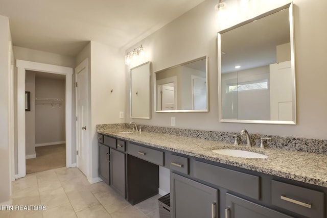 bathroom featuring tile patterned flooring and vanity