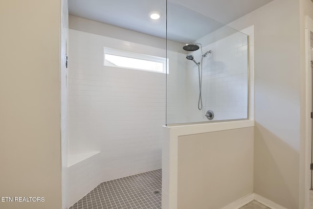 bathroom with a tile shower