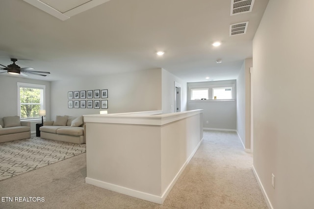 corridor featuring light colored carpet