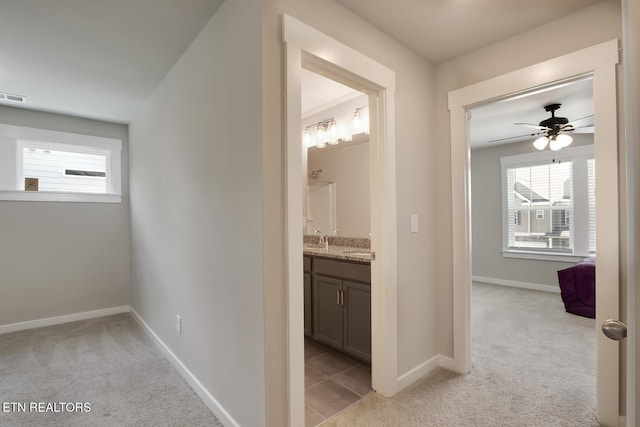 corridor with light colored carpet