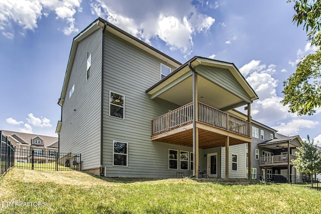 back of property featuring a yard and a wooden deck