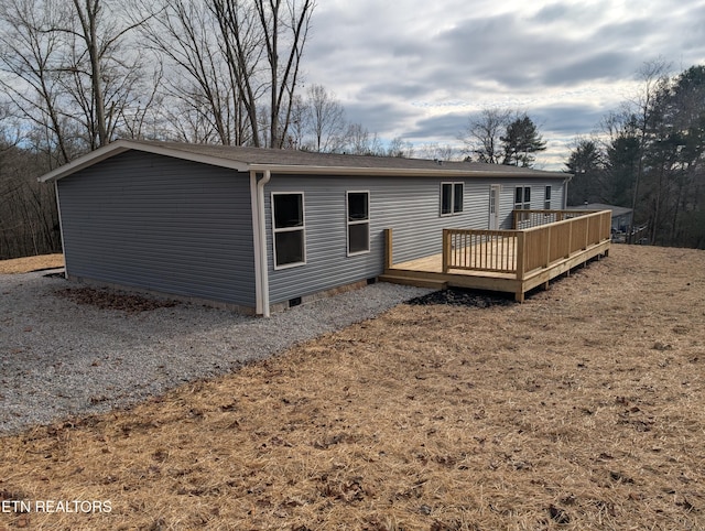 rear view of property featuring a wooden deck