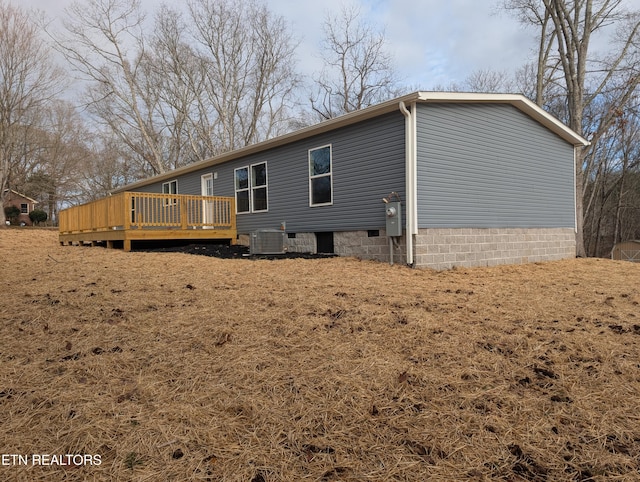 exterior space featuring central air condition unit and a wooden deck