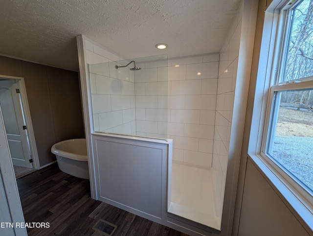 bathroom featuring hardwood / wood-style floors, a textured ceiling, and independent shower and bath