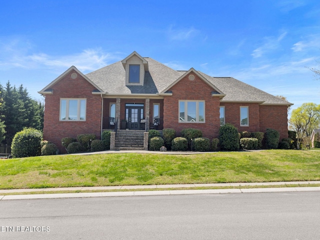 view of front of property with a porch and a front yard