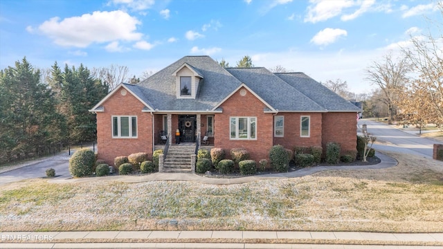 view of front of home with a front yard and a porch