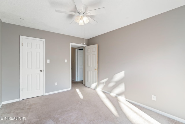 unfurnished bedroom featuring ceiling fan and light colored carpet