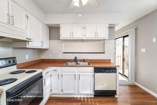 kitchen with white dishwasher, electric range oven, white cabinets, and sink