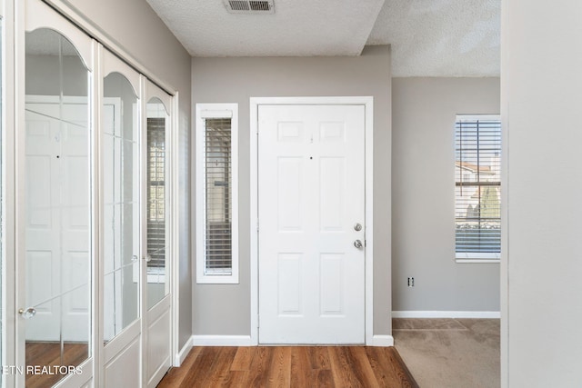 doorway featuring a textured ceiling