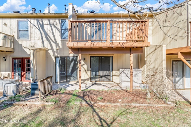 back of property featuring a patio, a balcony, and central AC unit