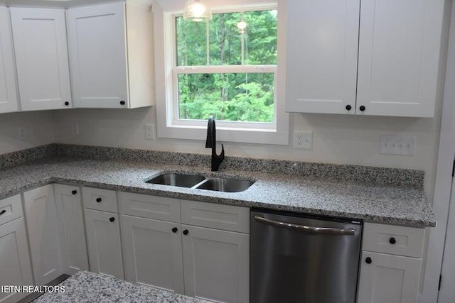 kitchen featuring sink, stainless steel dishwasher, and white cabinets