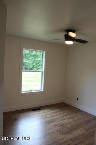 empty room featuring hardwood / wood-style floors and ceiling fan