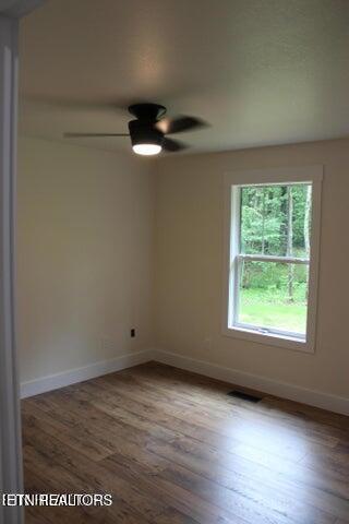 unfurnished room featuring hardwood / wood-style floors and ceiling fan