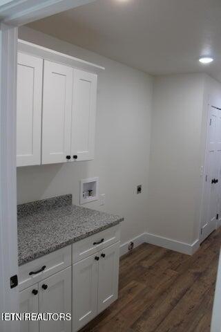 washroom with electric dryer hookup, dark hardwood / wood-style floors, cabinets, and hookup for a washing machine