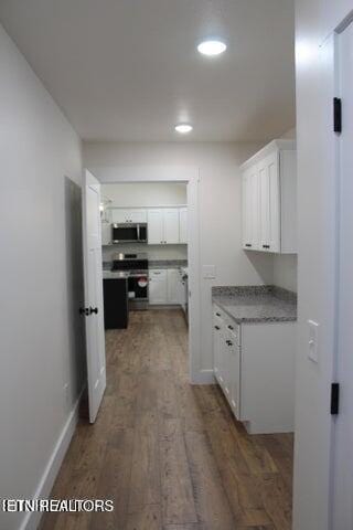 corridor featuring dark wood-type flooring