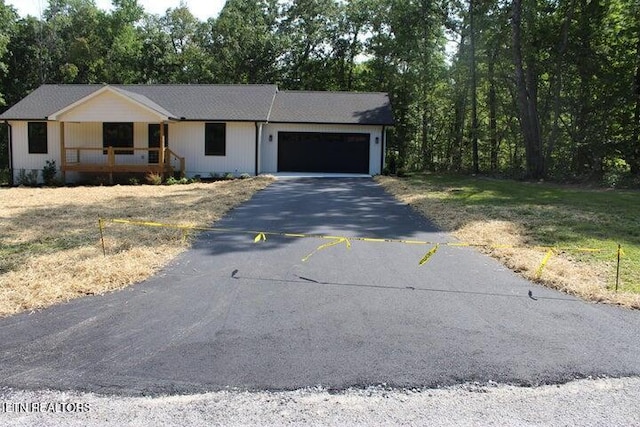 ranch-style house with a porch and a garage