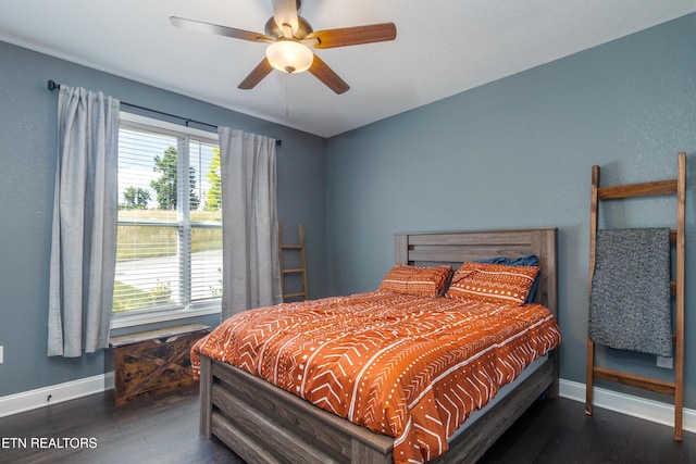 bedroom with ceiling fan, multiple windows, and dark hardwood / wood-style floors