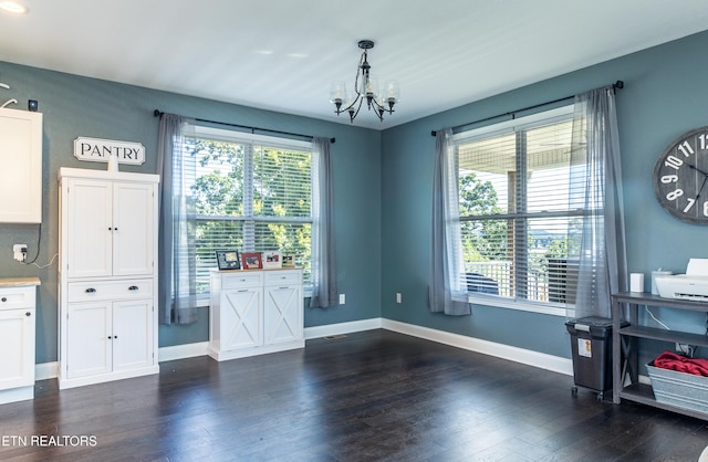 interior space featuring white cabinetry, a chandelier, dark hardwood / wood-style floors, and hanging light fixtures