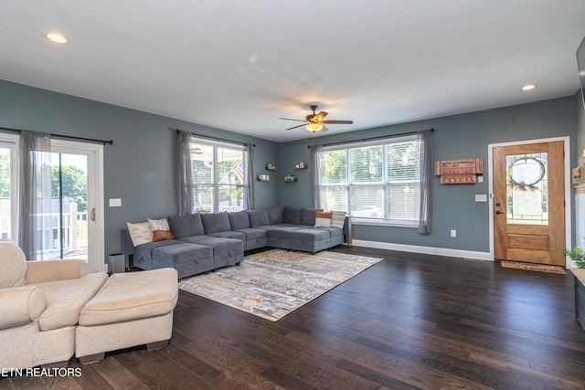 living room featuring ceiling fan, dark hardwood / wood-style flooring, and a wealth of natural light