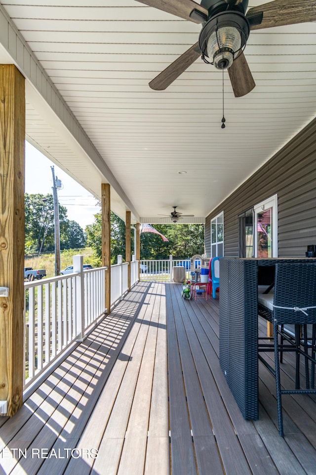 wooden deck with ceiling fan and covered porch