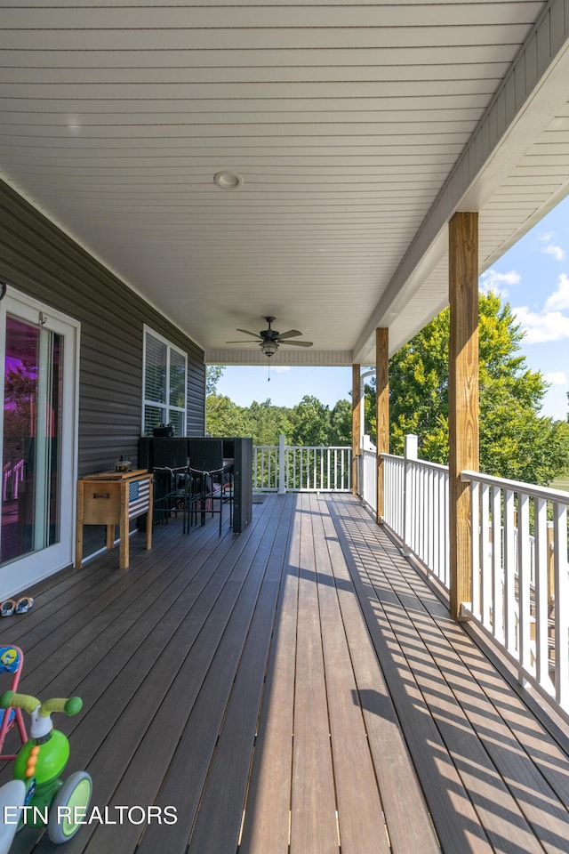 wooden terrace featuring ceiling fan