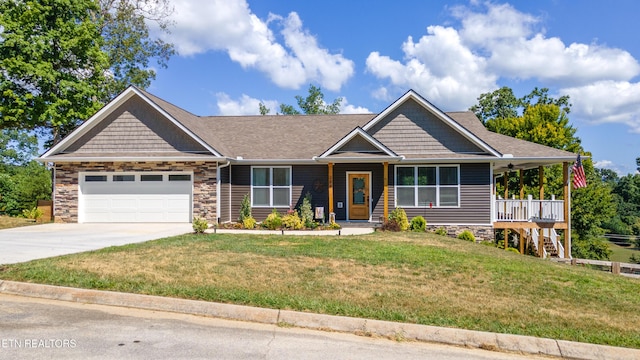 craftsman-style house with a front yard, a garage, and a porch