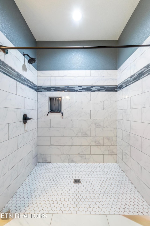 bathroom with tiled shower