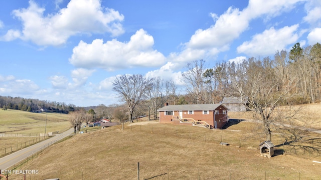 view of yard featuring fence and a rural view