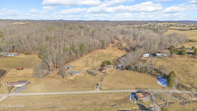 aerial view featuring a forest view and a rural view