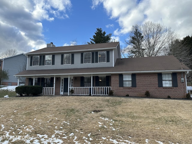 view of front of house with a porch and a front yard