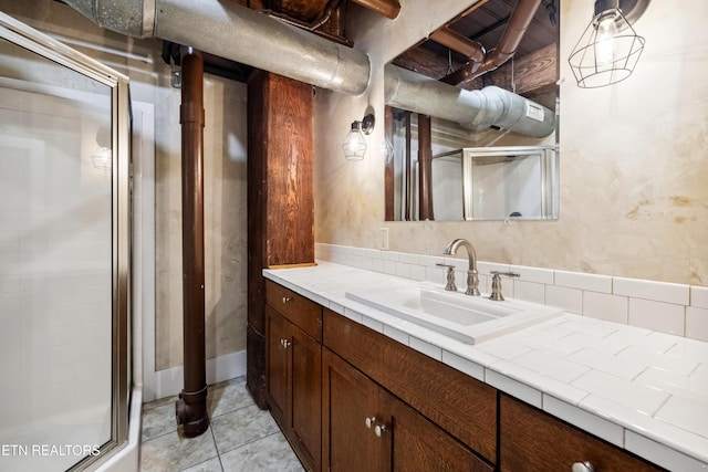 bathroom with vanity, tile patterned floors, and a shower with door