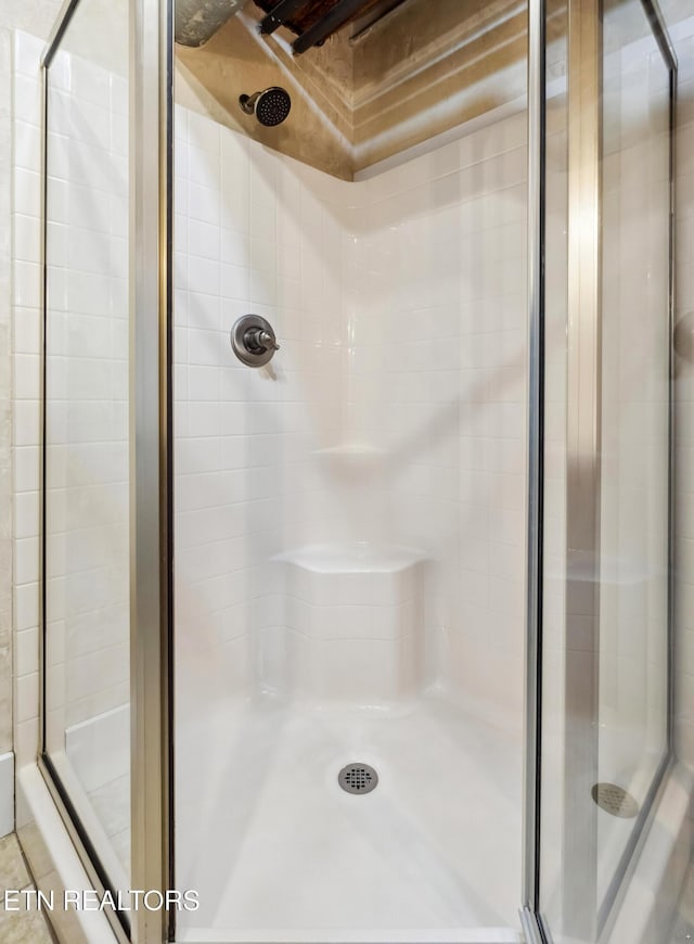 bathroom with a shower with door