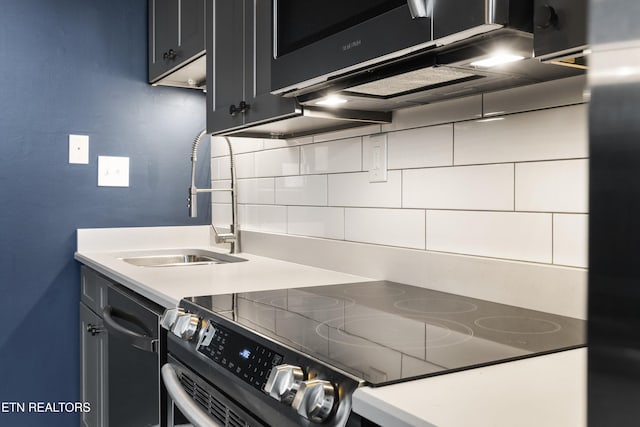 kitchen with backsplash, sink, and range