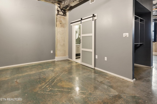 interior space with a towering ceiling and a barn door