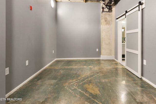 unfurnished room with a barn door